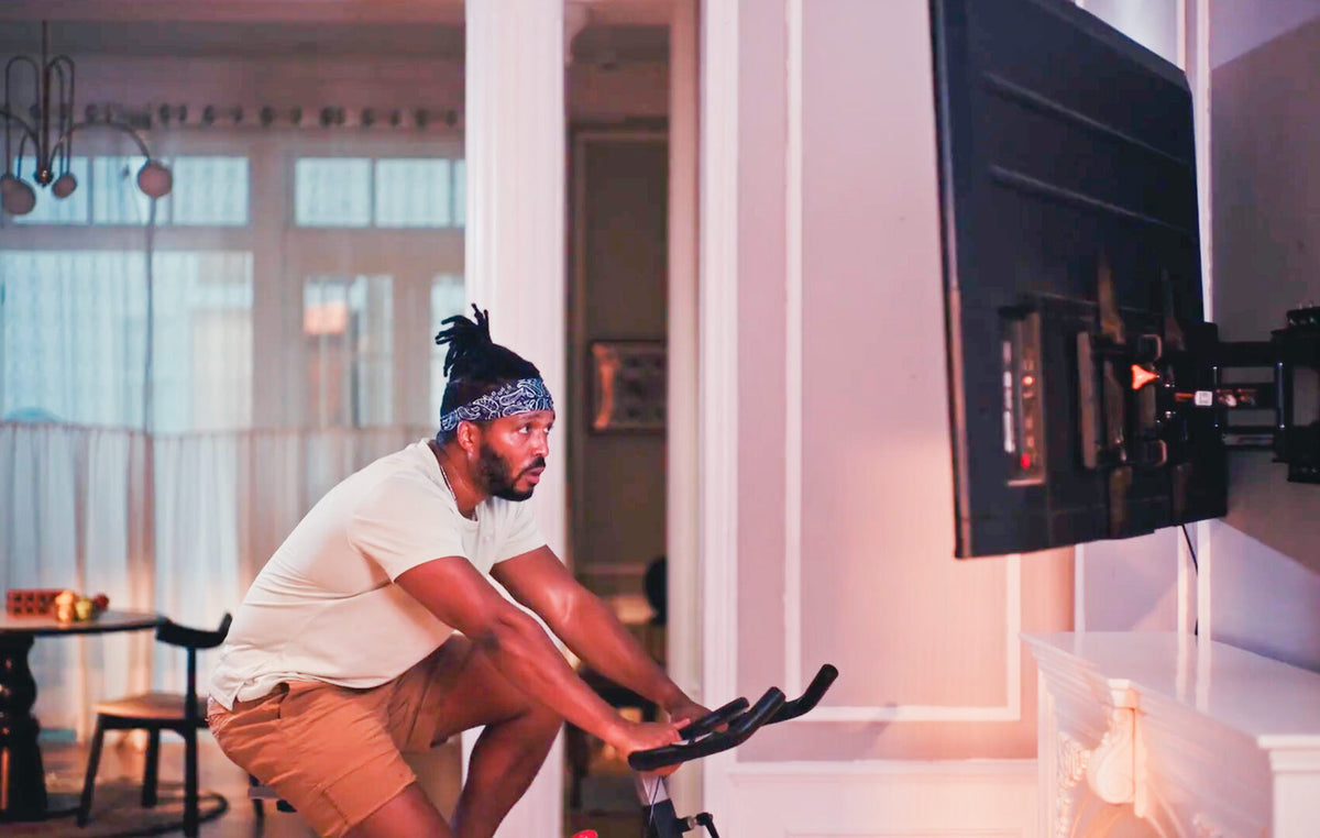 A living room: cycling in front of the mounted screen
